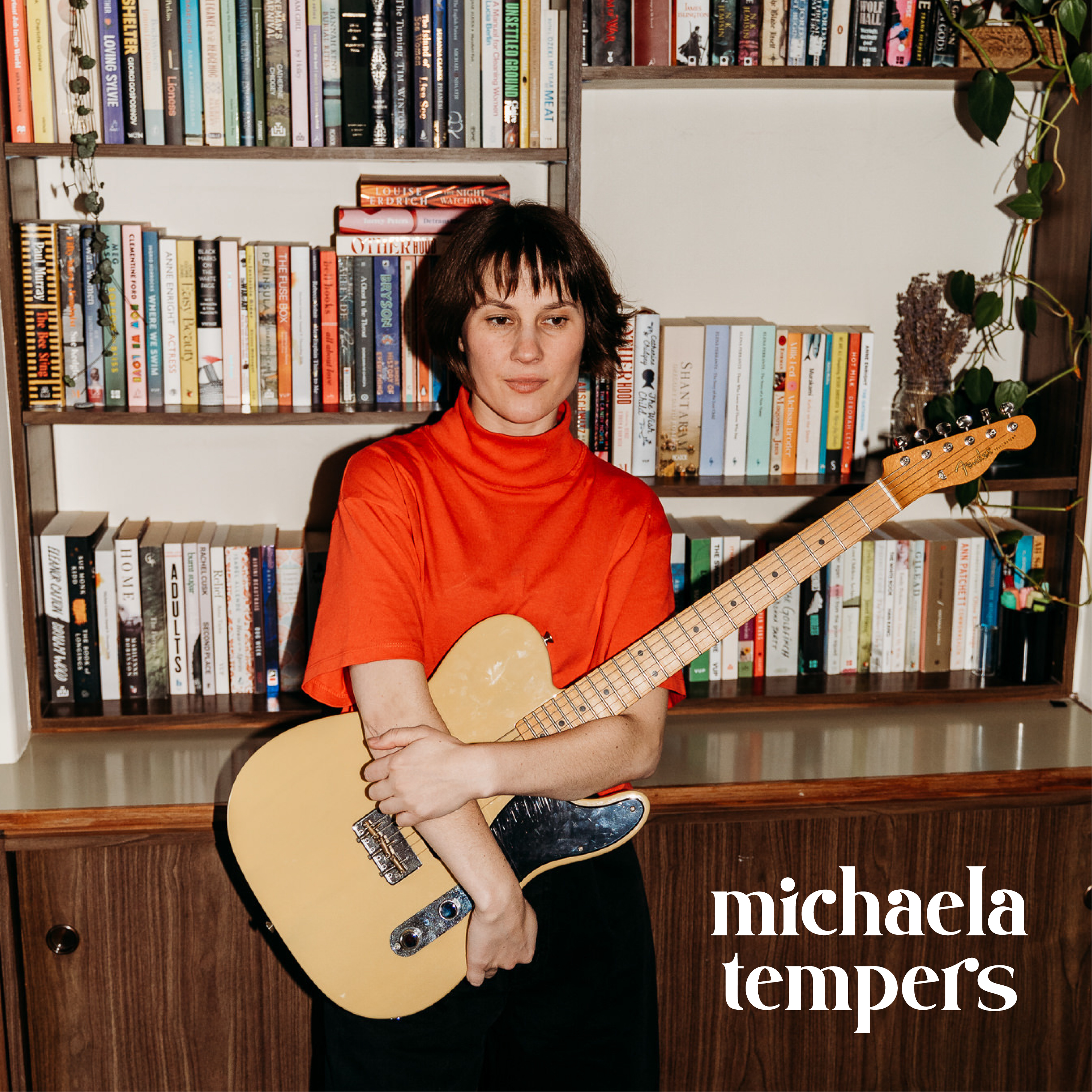 Good Woman EP cover — Michaela Tempers holding a guitar in front of a bookshelf, wearing a red top